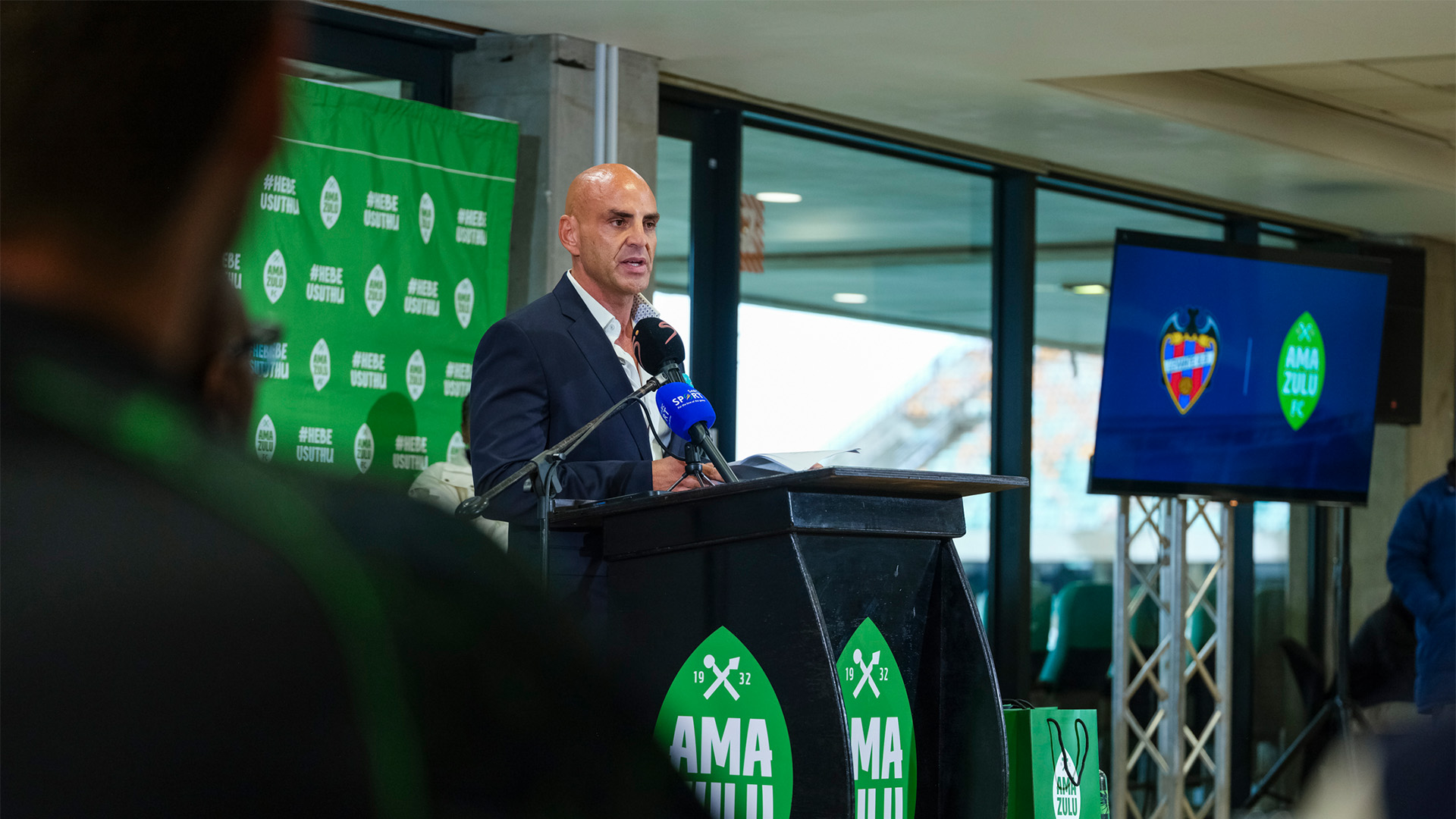 ISAM360 Founder and CEO Marcos Maisano speaks at a podium during the AmaZulu FC and Levante UD partnership announcement.